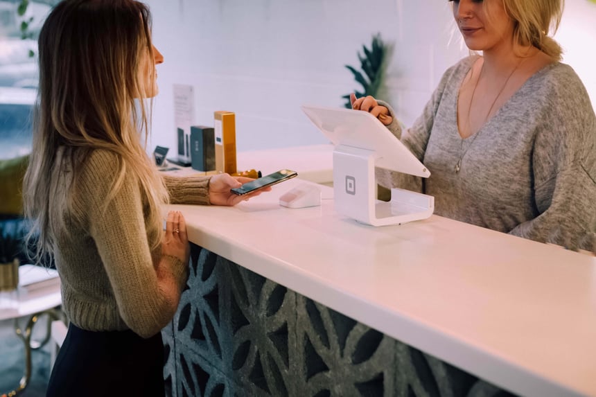 two women completing a transaction at a small business