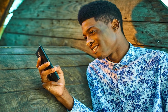 young man texting on smartphone
