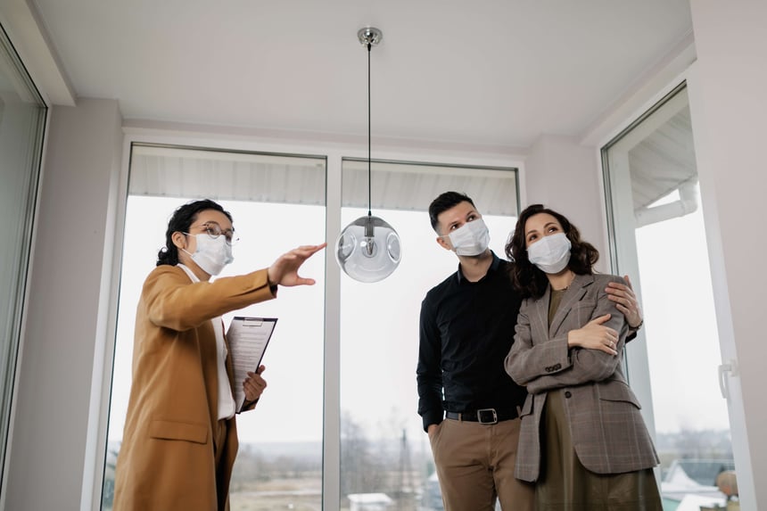 real estate agent showing a home to a couple