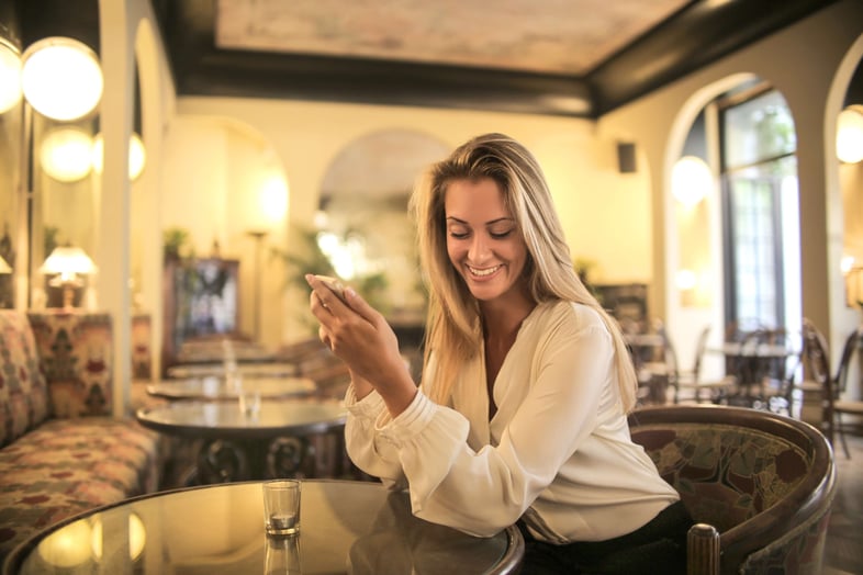 smiling woman holding her phone