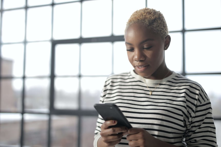 woman holding her phone and texting