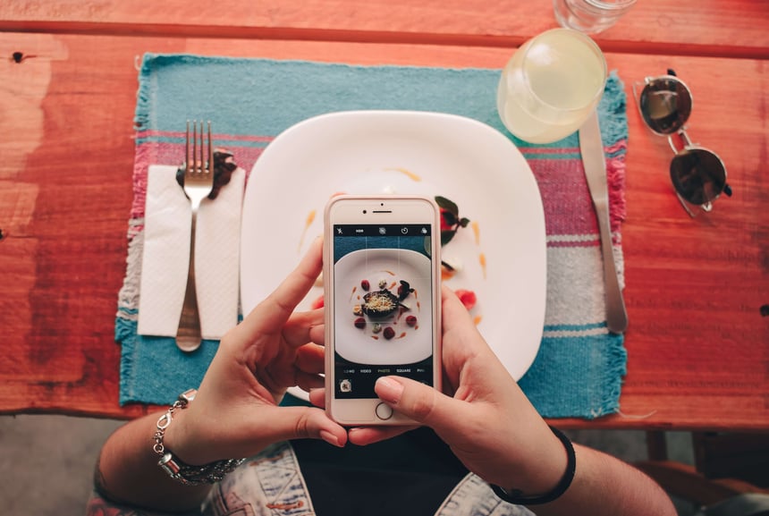 person taking a picture of their food